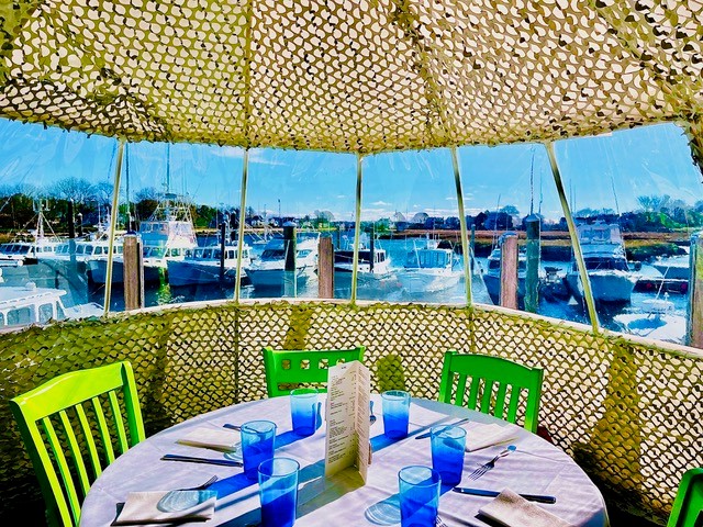 Igloo dining on the water looking at boats and water