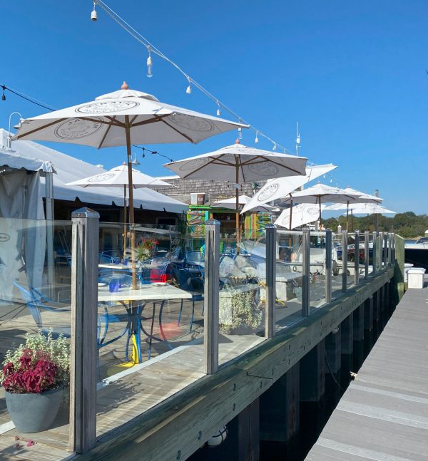 Bridge Deck on the water with umbrellas and tables