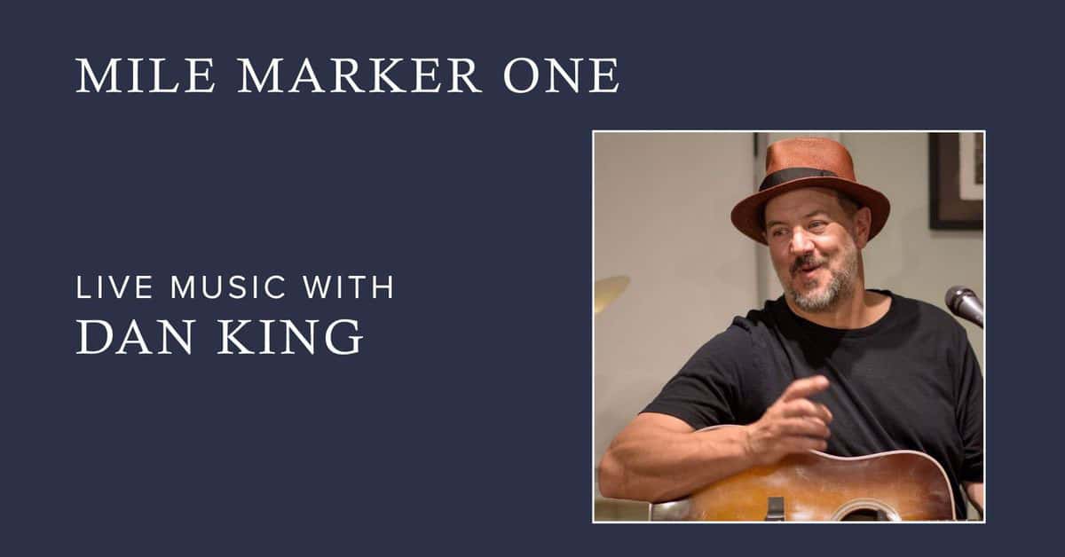 Guy in a hat playing guitar