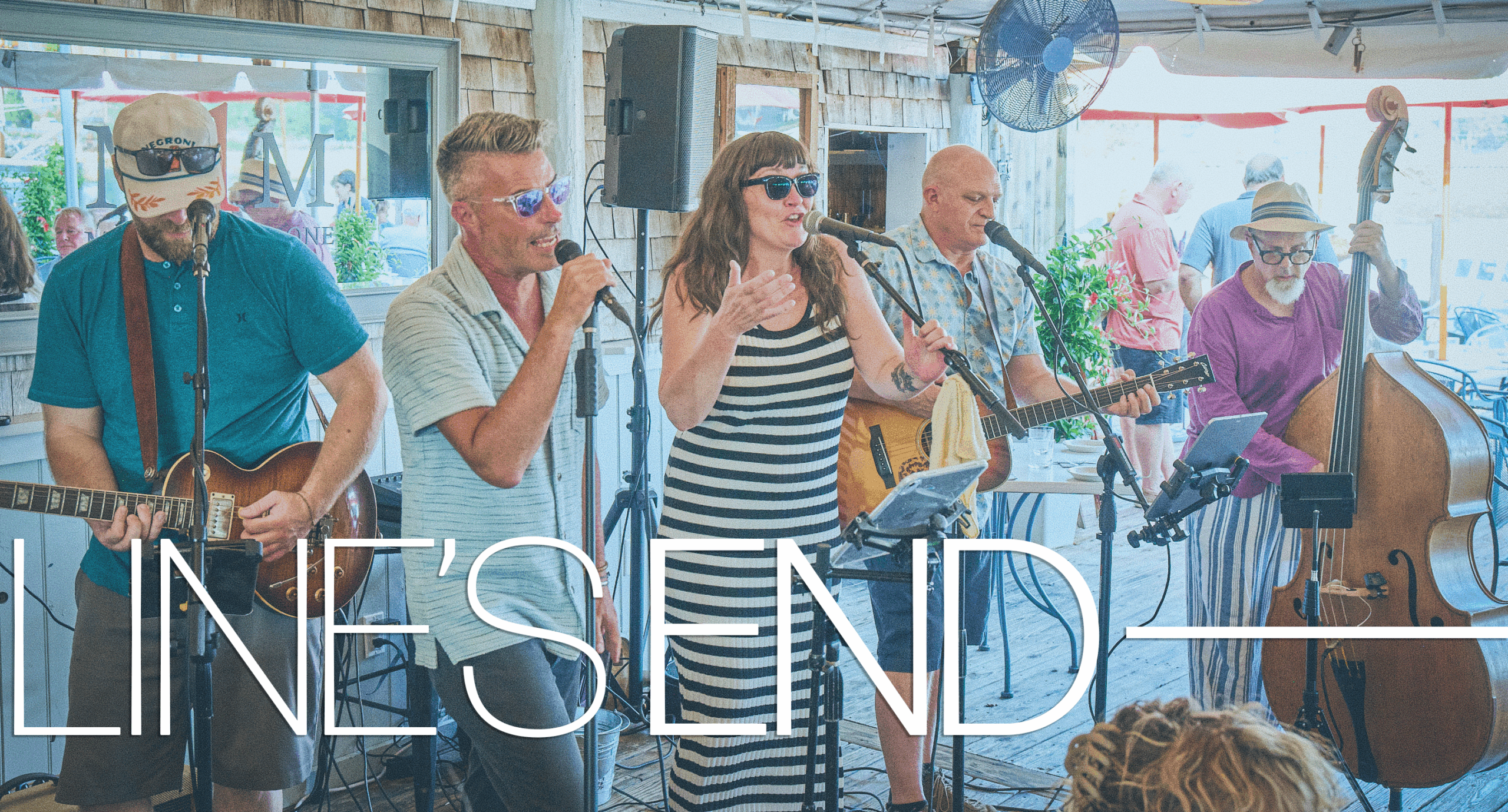 a band of people singing on a deck
