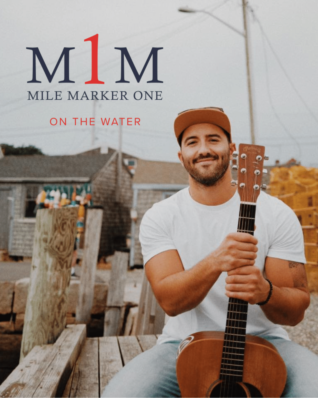 Guy on a pier with a guitar