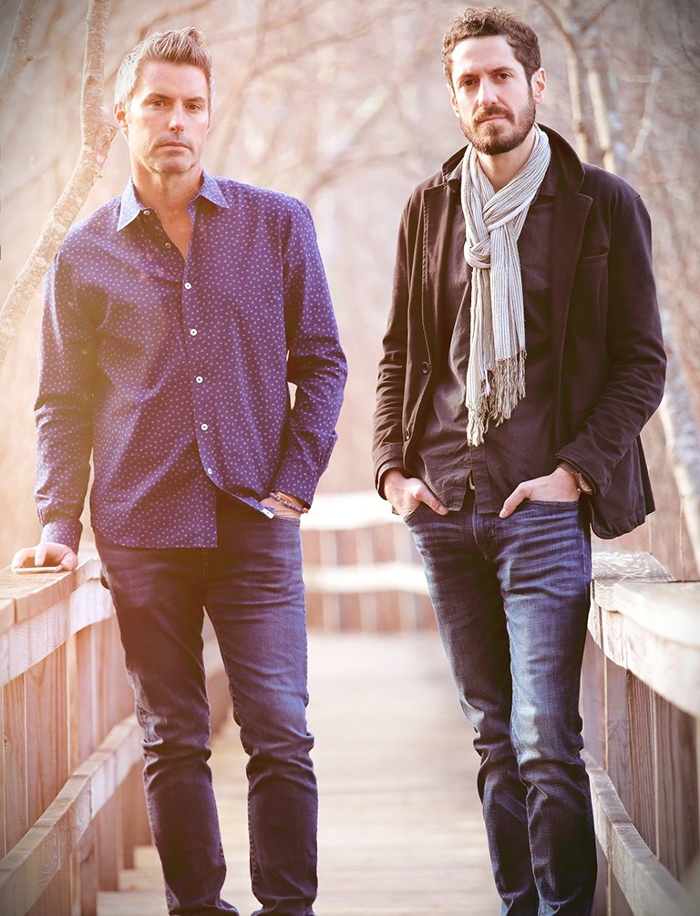 TWO MEN IN PANTS SN JACKET ON A WOOD WALKWAY