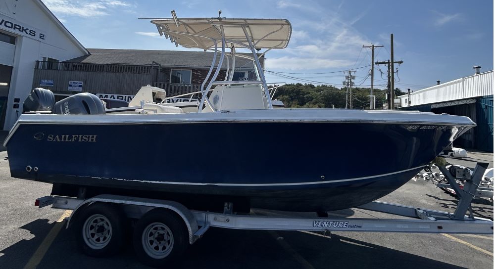 Side view of a blue center console sailfish 220 boat