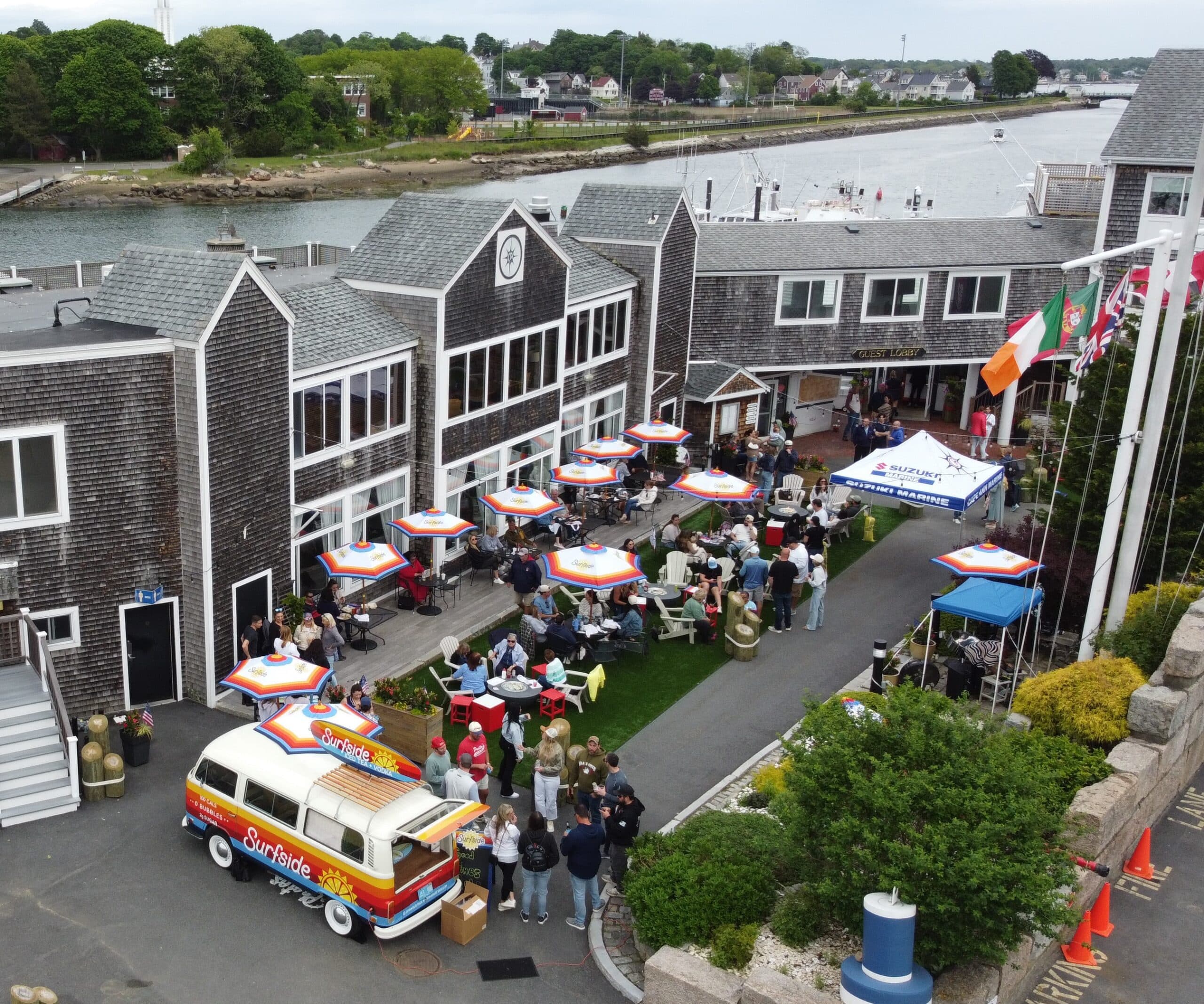 aerial of marina courtyard with umbrella tables and people mingling
