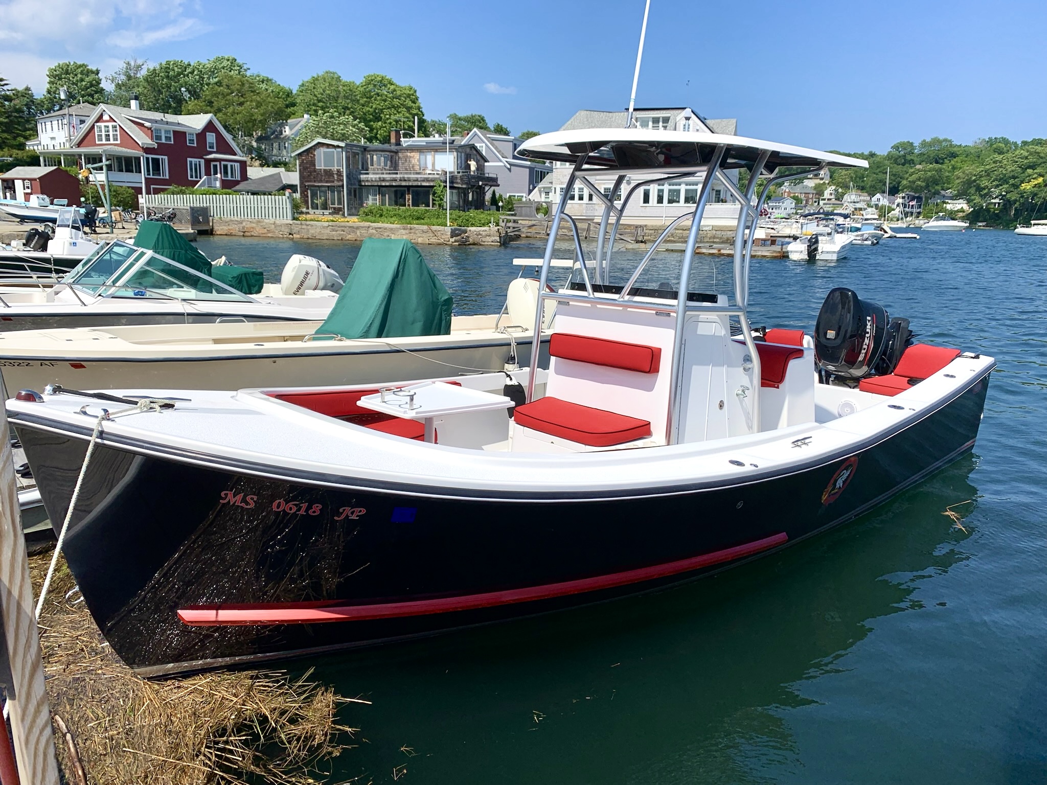 Center console dark hull boat inthe water
