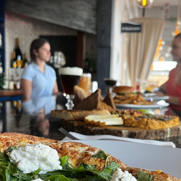 Pizza on a bar with wine at Mile Marker One