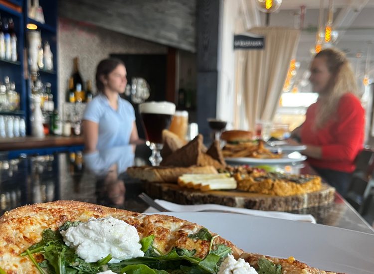 Pizza on a bar with wine at Mile Marker One