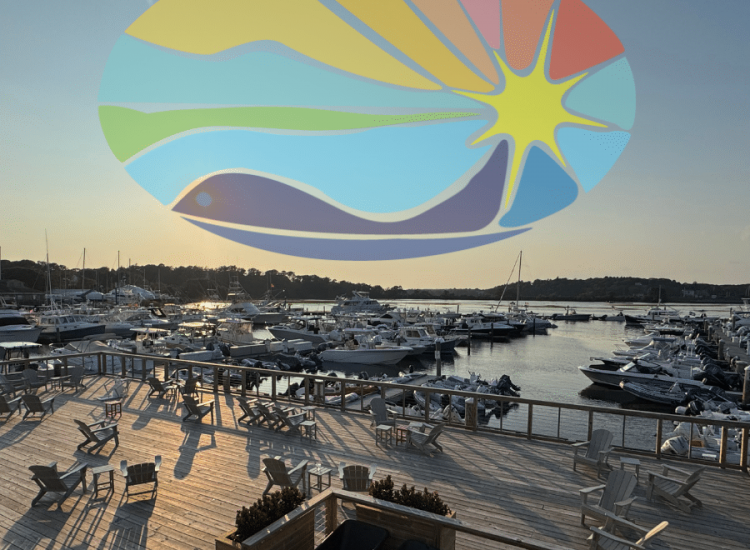 sun logo in the sunset sky with a deck and chairs overlooking boats at a marina