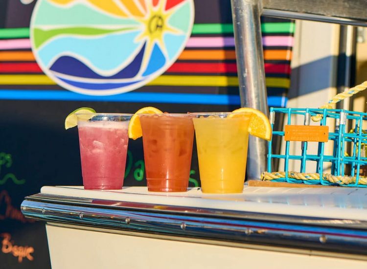 Sun deck logo and three cocktails on a bar top