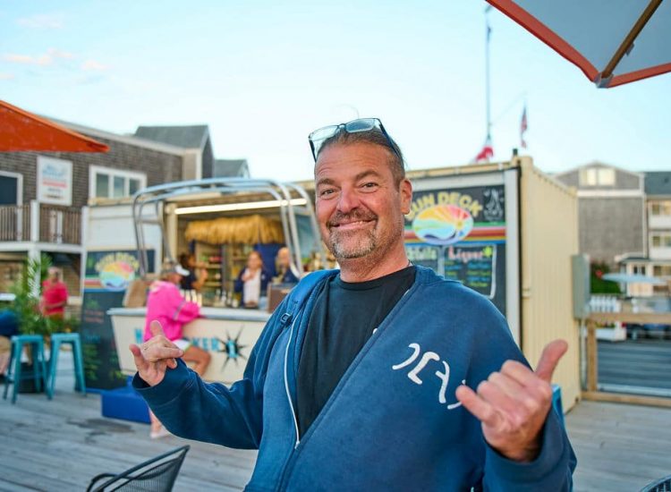 man with glasses and beard giving a thumbs up on the sun deck