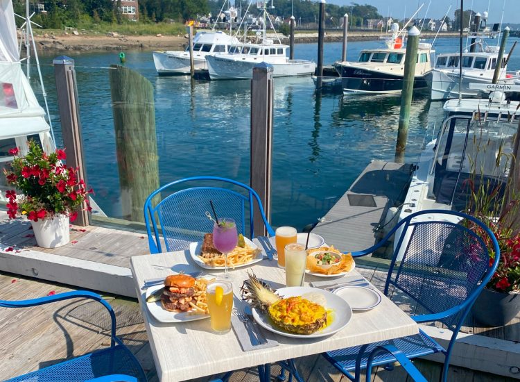 Deck dining overlooking boats and marina and fresh seafood