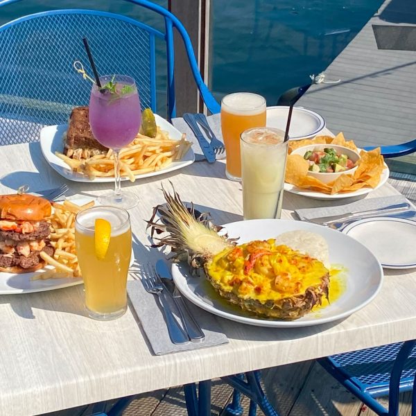 Deck dining overlooking boats and marina and fresh seafood