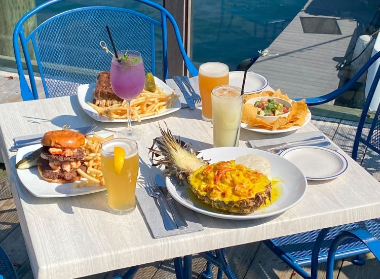 Deck dining overlooking boats and marina and fresh seafood