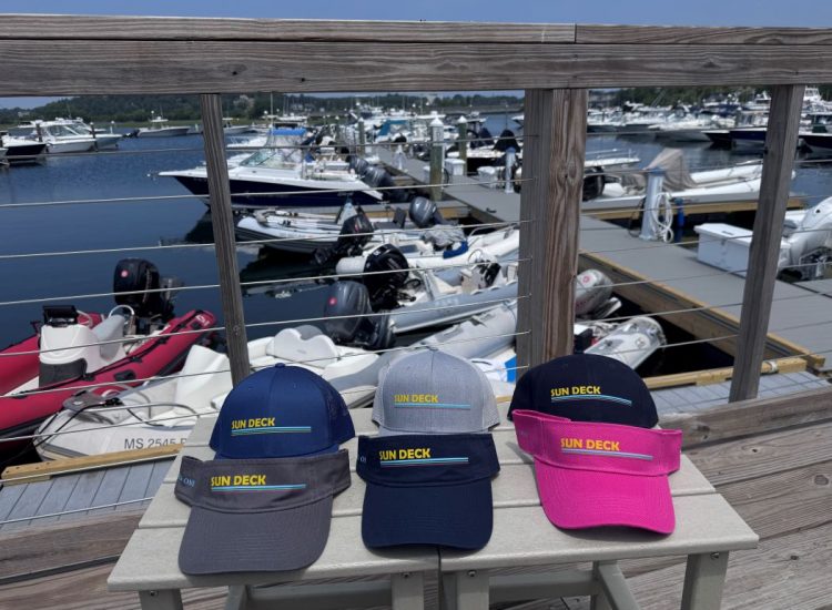 Colorful trucker hats SunDeck with marina behind