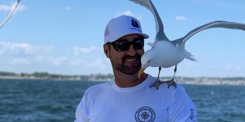 man with seagull bird on shoulder
