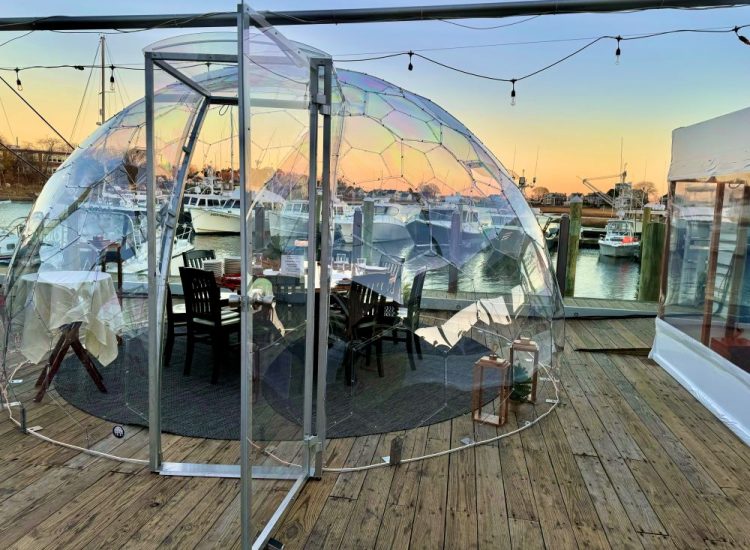 clear dome igloo table setup for dining at sunset