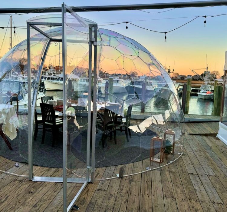 clear dome igloo table setup for dining at sunset