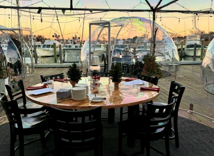 clear dome igloo table setup for dining at sunset