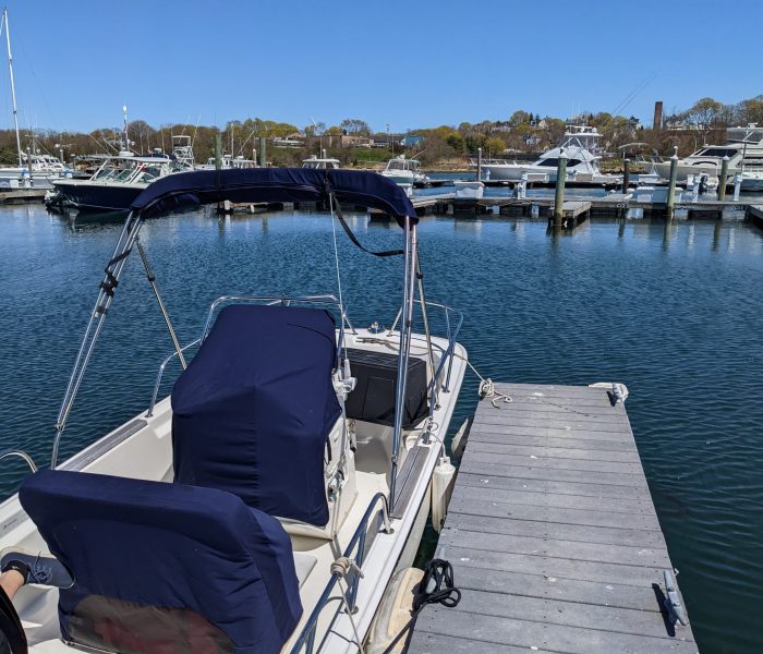 small boat in the water with covers on it
