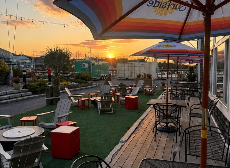 Sunset tables chairs umbrellas courtyard at Cape Ann Marina