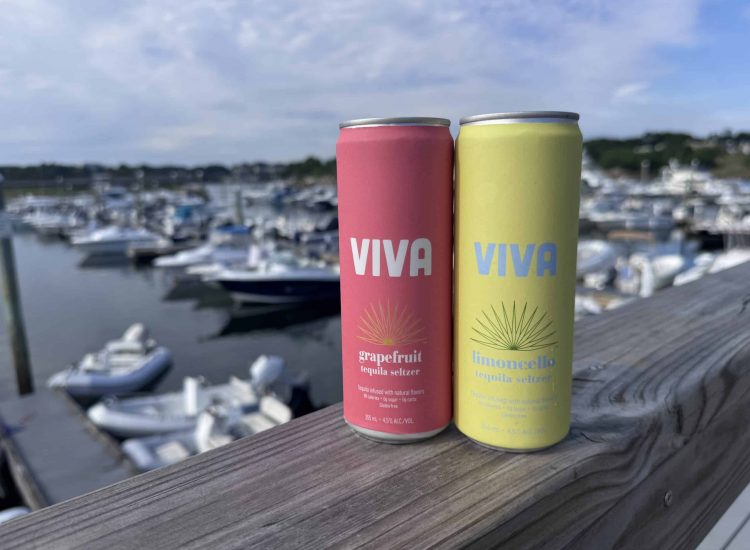 two ViVA drinks on a railing over looking boats