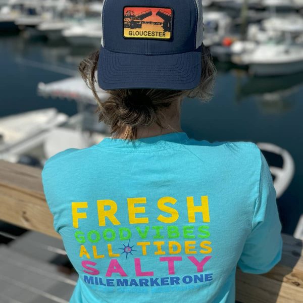 Aqua Tshirt and hat backwards on female