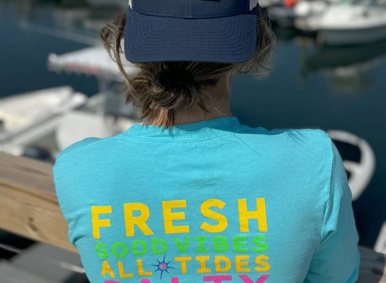 Aqua Tshirt and hat backwards on female