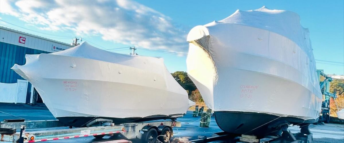 two boats on a trailer with shrinkwrpa