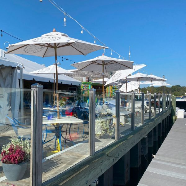 Bridge Deck on the water with umbrellas and tables