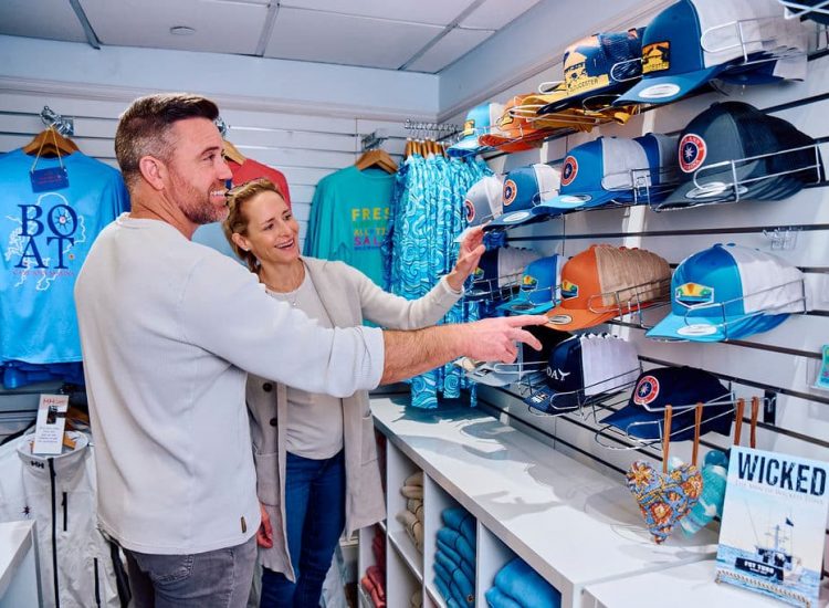 male and female shopping in retail store looking at trucker hats